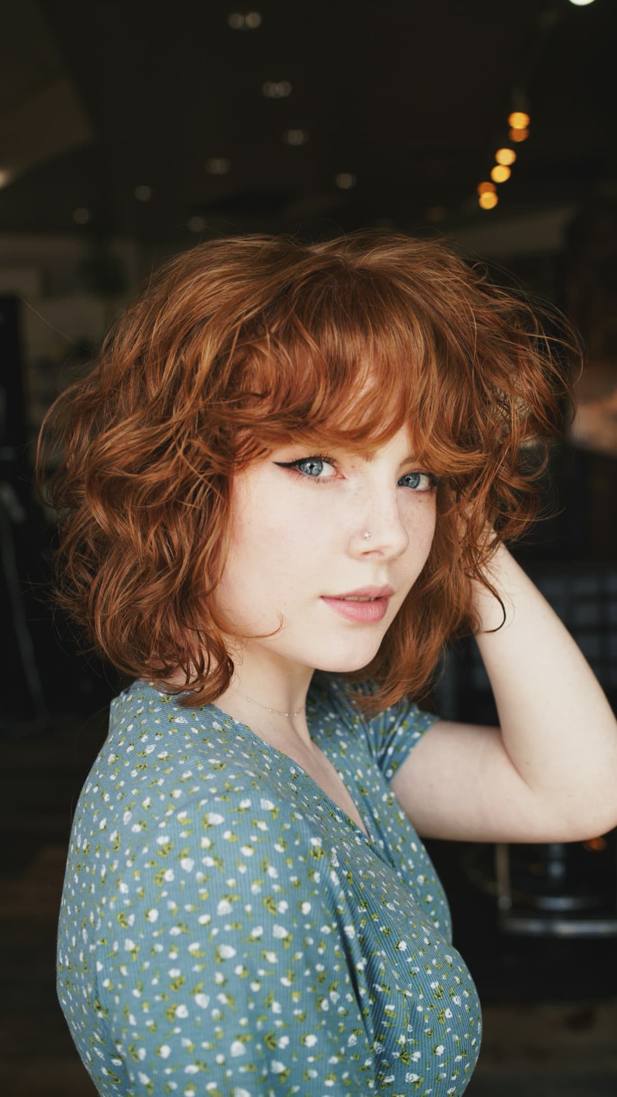 Curly red bob in salon